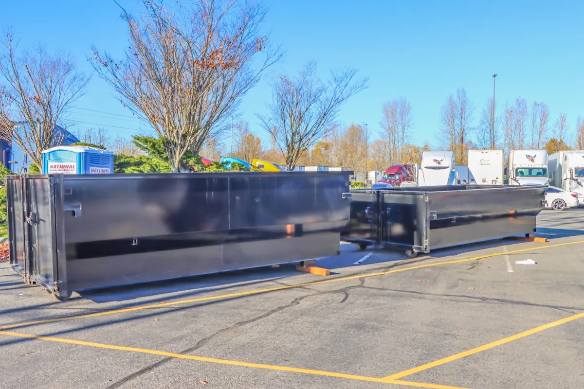 Professional dumpster rental service with roll-off container on residential driveway in Bayville